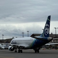 Alaska Airlines aircraft & aircraft at boarding bridge