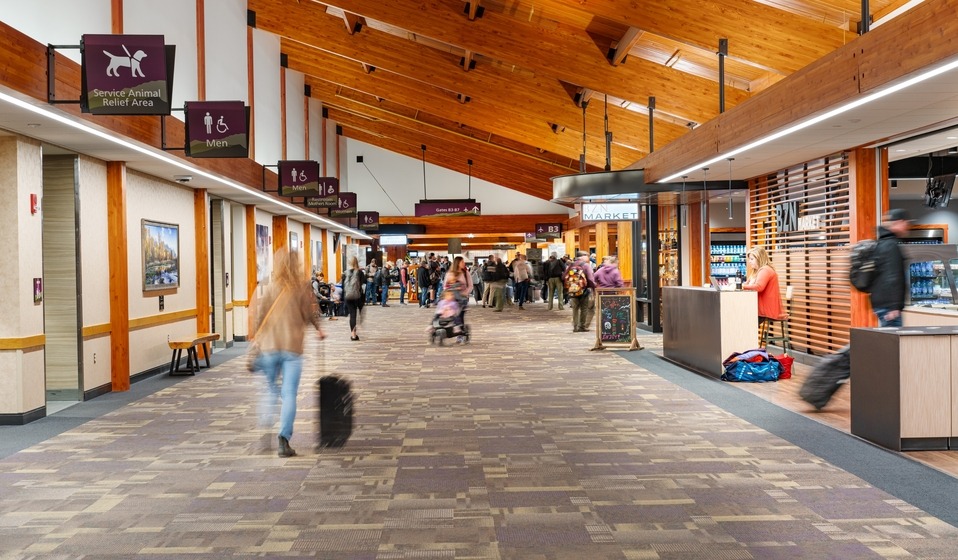 B Concourse hallway busy passenger traffic by BZN Market