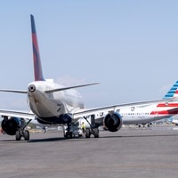 delta on ramp, american push back, alaska in the distance 